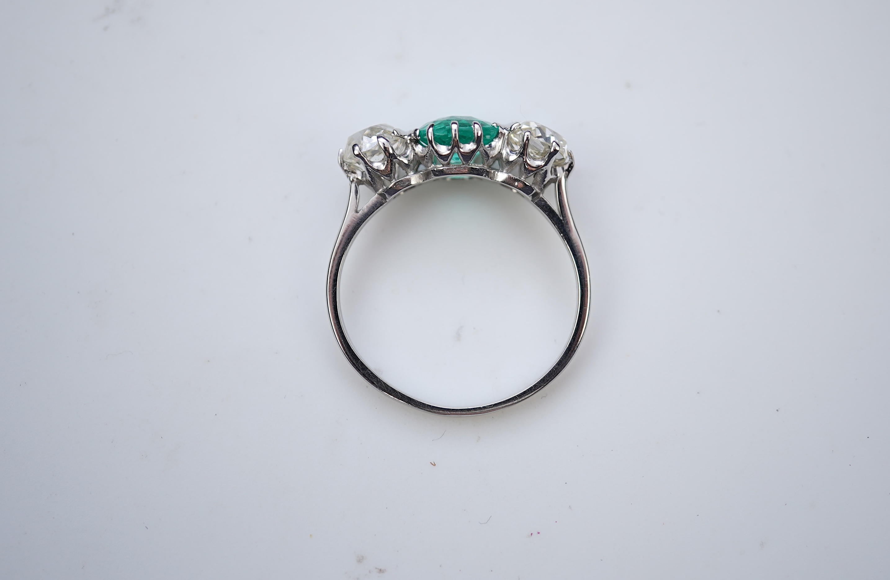 An attractive emerald and diamond three-stone ring, early 20th century